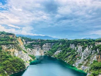 Scenic view of river amidst mountains against sky