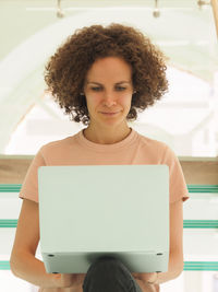Portrait of young woman using laptop