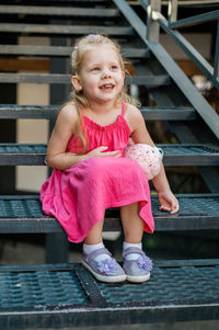 Portrait of girl sitting on staircase