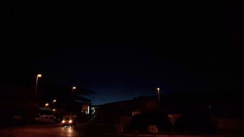 Illuminated car against sky at night