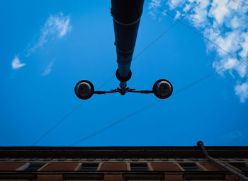 Low angle view of street light against blue sky