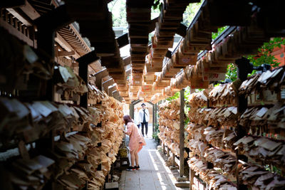 Rear view of man walking in warehouse