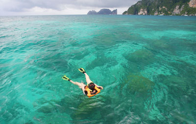 High angle view of woman swimming in sea