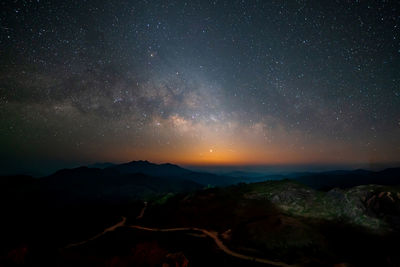 Scenic view of mountains against sky at night