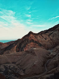 Rock formations on landscape against sky