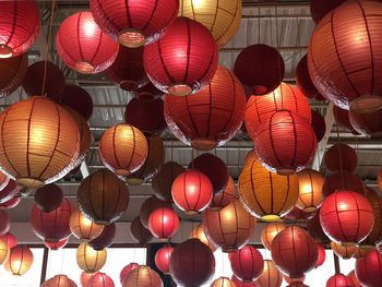 Low angle view of illuminated lanterns hanging on ceiling