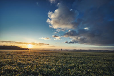 Scenic view of field against sky during sunset