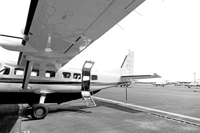 Airplane on airport runway against clear sky