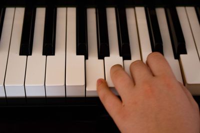 Close-up of hands playing piano