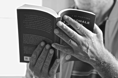 Close-up of hand holding book