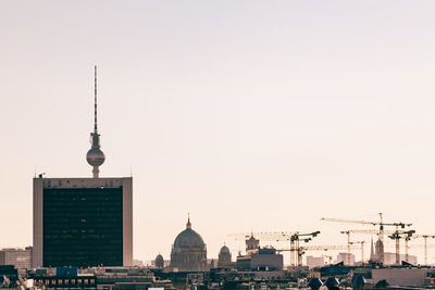 Fernsehturm in city against clear sky