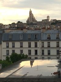 Buildings against cloudy sky