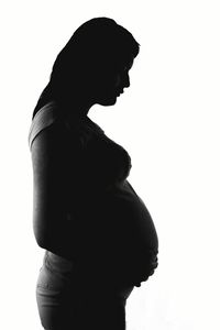 Low angle view of woman against white background