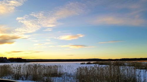 Scenic view of lake against sky during sunset