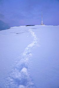 Snow on shore against sky