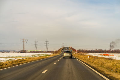 Cars on road against sky