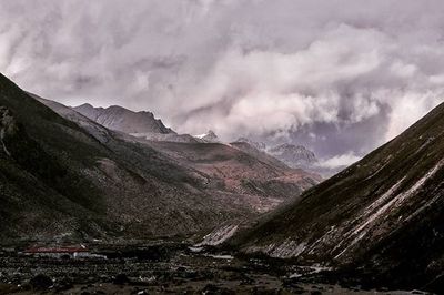 Scenic view of mountains against cloudy sky