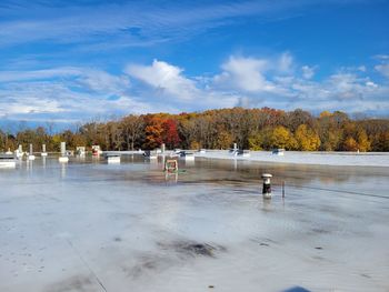 Scenic view of roof water against sky during autumn 