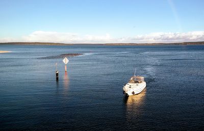 Motorboat in sea against sky