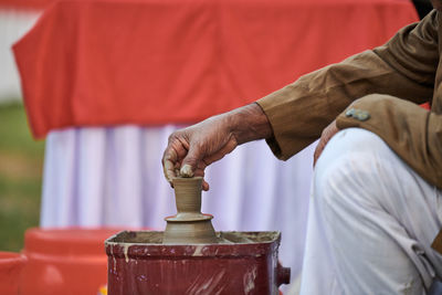 Cropped hand of man working at workshop