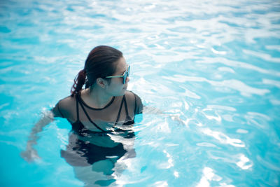 Full length of girl swimming in pool