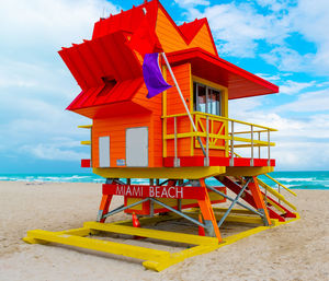 Lifeguard hut on beach against sky