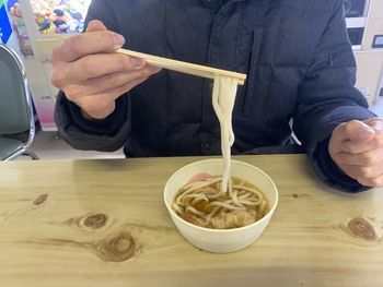 Midsection of man having food in restaurant