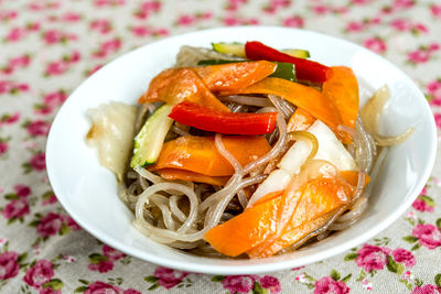 Close-up of noodles with vegetables served in bowl on table