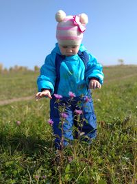 Cute boy standing on field