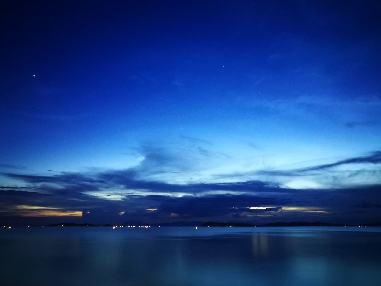 water, beauty in nature, sky, reflection, scenics, blue, tranquil scene, tranquility, nature, waterfront, no people, lake, night, cloud - sky, outdoors, illuminated, moon