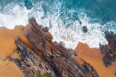 Waves splashing on rocks at shore