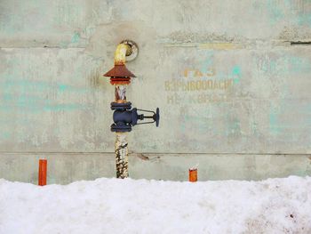 Text on snow covered wall