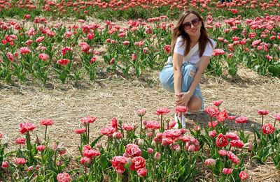 Portrait of woman with red flowers