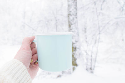 Woman holding coffee cup