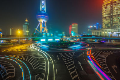 Light trails on road in city at night