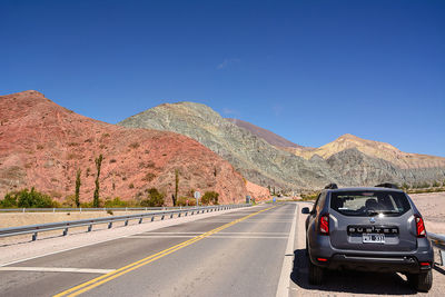 Cars on road against clear sky