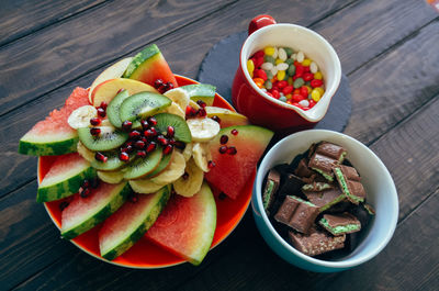 High angle view of chopped fruits in bowl on table