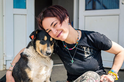 Dog at the shelter. animal shelter volunteer takes care of dogs. lonely dogs in cage with volunteer.