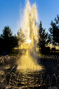 Illuminated fountain at night