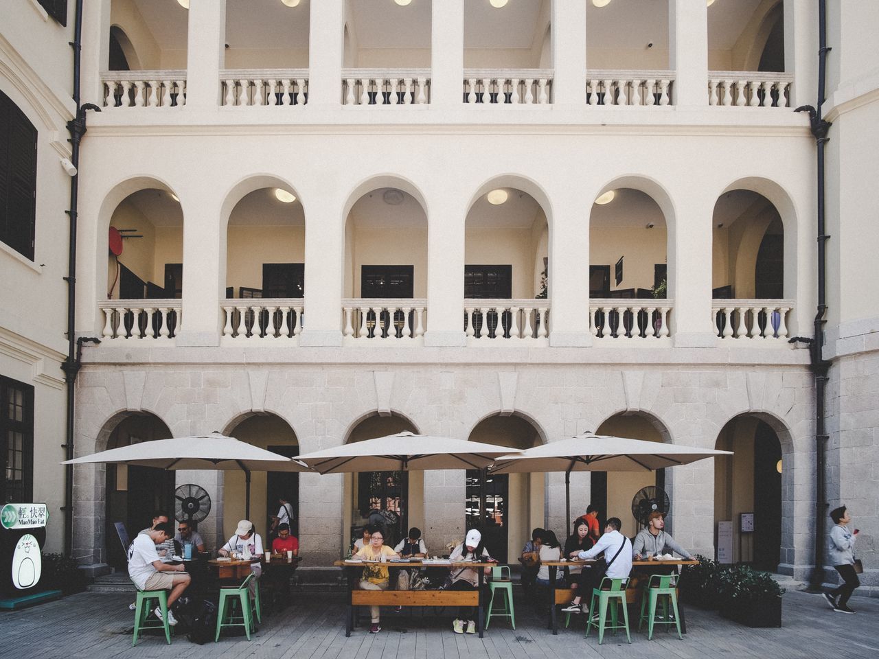 architecture, group of people, building exterior, built structure, arch, men, women, real people, adult, city, lifestyles, leisure activity, day, building, table, cafe, crowd, people, sitting, seat, outdoors, architectural column