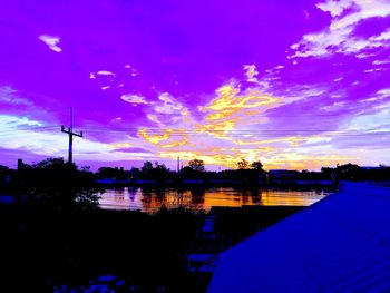 Silhouette buildings against sky during sunset