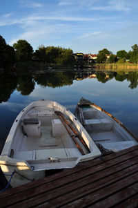 Boat moored in lake against sky