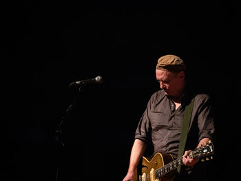 Man playing guitar at music concert