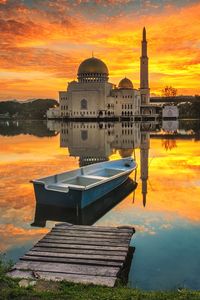 Reflection of building in lake during sunset