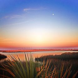 Scenic view of landscape against sky at sunset