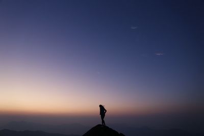 Silhouette of woman standing on landscape