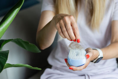 Midsection of woman holding plant