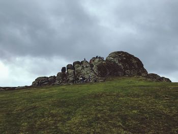 Low angle view of rocks on landscape against sky