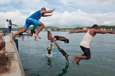 People jumping in water