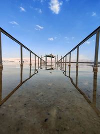 Bridge over sea against sky